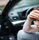 Woman worried in the car making a phone call