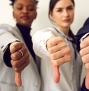 disappointed young multiethnic people give thumbs down