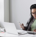 woman accountant using calculator and computer in office 