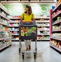 woman with shopping between store shelf