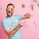 man with dollar-sign glasses throwing money