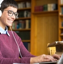 Girl with headphones smile and type