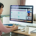 woman talking to her colleagues about plan in video conference