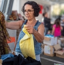 woman choosing clothes at garage sale