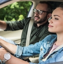 Student driving a car with teacher