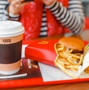 hamburger drink and fries on a tray in McDonald fast food restaurant