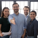 male leader stretch out his hand for handshake welcoming new employee