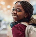 a woman in an airport looking back and smiling