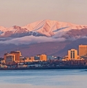 sun setting over anchorage skyline