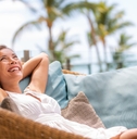 woman enjoying sofa furniture of outdoor patio