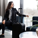 a woman waiting in an airport lounge for her flight
