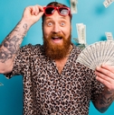 man with tattoo holds fan of money