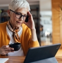 senior lady in stress looking at laptop