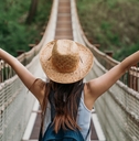 Happy woman traveler on a bridge