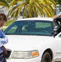 police stopped a man in car and is interrogating him