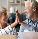 elderly couple giving high five