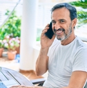 middle age man with beard smiling happy at the terrace 