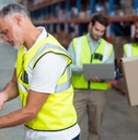 worker scanning boxes in a warehouse