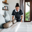 housekeeper cleaning a hotel room