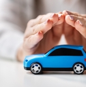 hands protecting a toy car