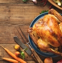 A roasted turkey on a wooden tabletop. 