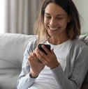 an adult woman playing a game on her phone