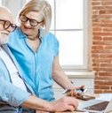 happy senior couple using laptop