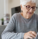 old woman at home using laptop computer