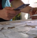 A person scans a paper receipt using their phone.