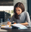 female student studying at college library