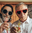 retired men wearing funny sunglasses drinking juice