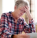 stressing senior lady reading document