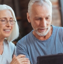 happy senior couple using tablet at home