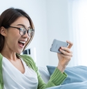 A young woman playing a mobile gaming app
