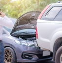Man looking at wrecked car