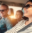 A happy family driving in a car