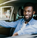 Smiling man driving a car