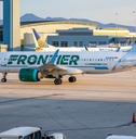 frontier airplane standing at las vegas airport during day time