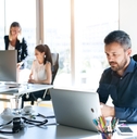 three businesspeople in the office working together