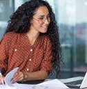 businesswoman working inside office with documents and laptop
