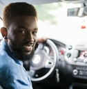 Smiling man driving a car