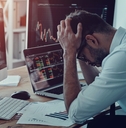 businessman keeping head in hands while sitting in the office