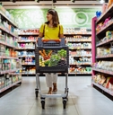 woman with shopping between store shelf