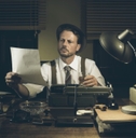 A person in old times reviewing a document