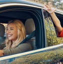 Parents driving a car with a child in the back seat