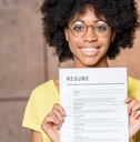 woman holding resume document indoors