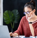 businesswoman looking at a notebook analyzing data