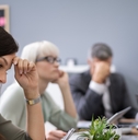 bunch of colleagues sad in presentation room at workplace
