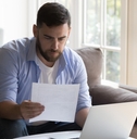 businessman doing paperwork at home