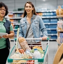 woman talks to supermarket worker adobe